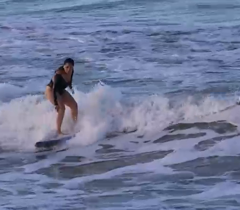Gisele surfing a wave in Brazil